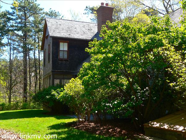 Back lawn, screened porch and golf course beyond