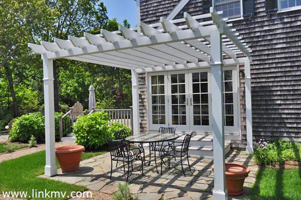 French Doors Open From The Kitchen & Dining Area To Bluestone Patio With Pergola For Outdoor Entertaining
