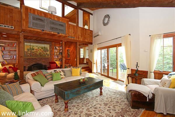 Living room with wood burning brick fireplace