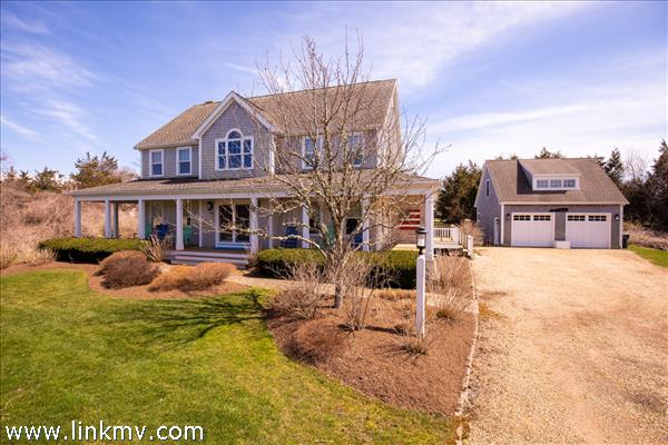 Front exterior of house and 2 car garage with detached bedroom above