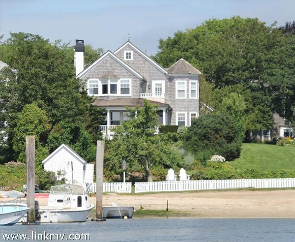 Expansive lawn with boathouse at left