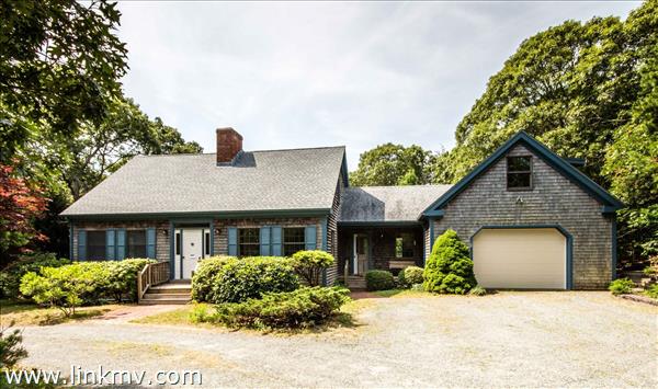Classic Cape style with breezeway and oversized garage.
